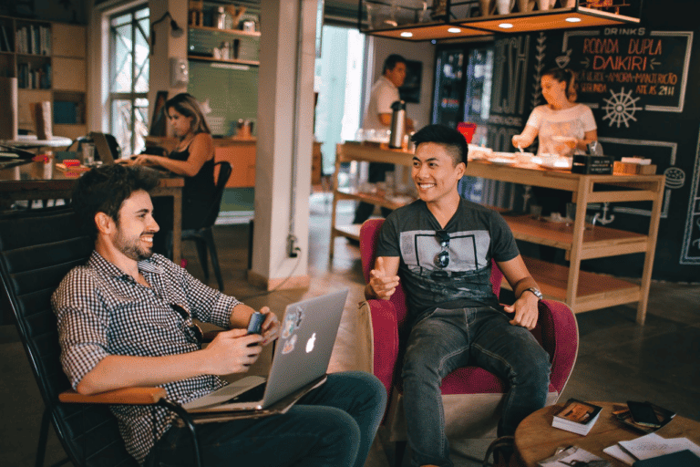 People smiling as they work and enjoy a coworking space