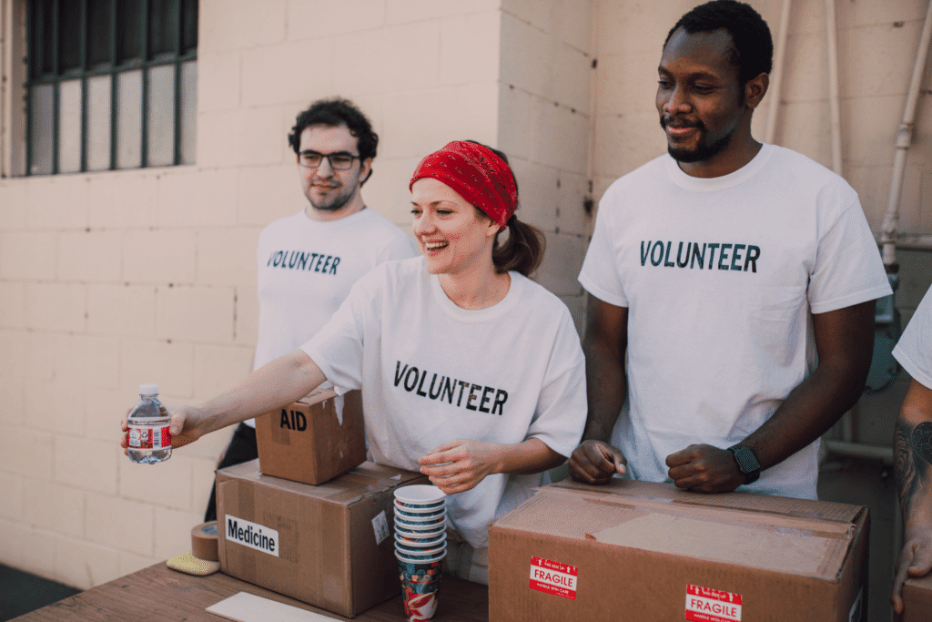 Three volunteers help to give back to the local community by providing medicine and first aid.